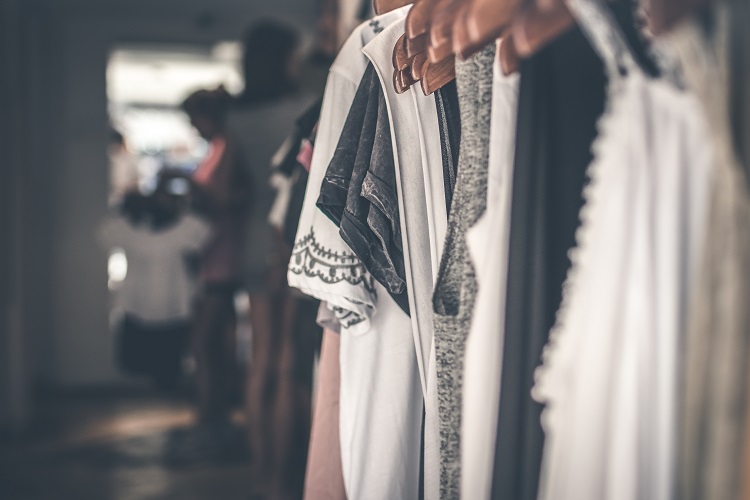 white and black clothes hanging from a rack